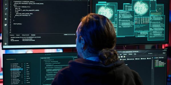Cybercriminal uploading USB flash drive containing stolen information into computer. Scammer inserting storage device containing sensitive data obtained from security breach