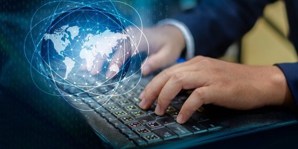 Press enter button on the computer. business logistics Communication network World map send message Connect worldwide hand keyboard Communications network map of the world Blue map Dark blue background map world global logistics network