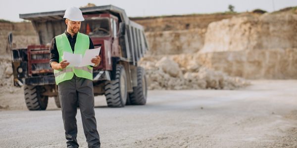 Male worker with bulldozer in sand quarry