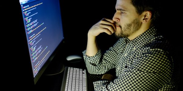 Software developer computer at dark home office. Startup and hard working concept